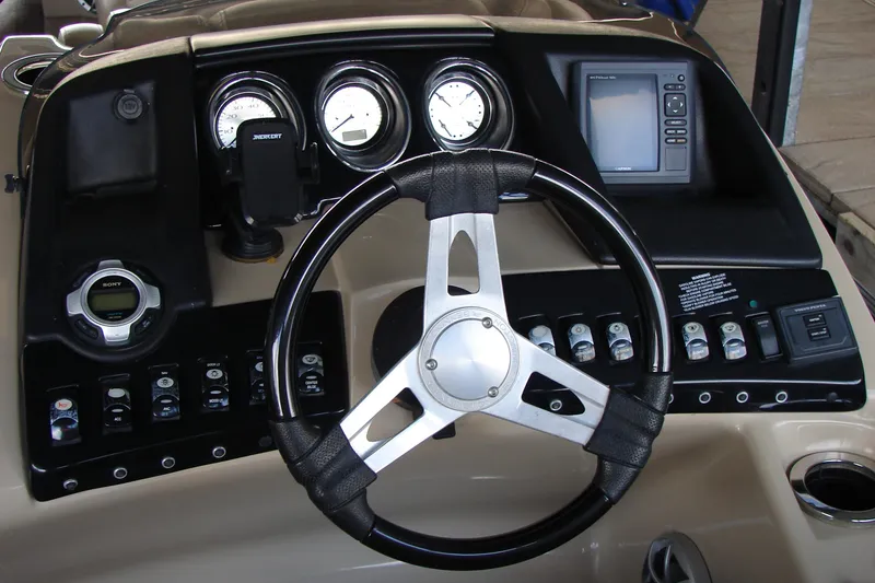 Slide: The Image of Dashboard of a 2015 Bennington 2875 QCW I/O boat with steering wheel and controls. - 19