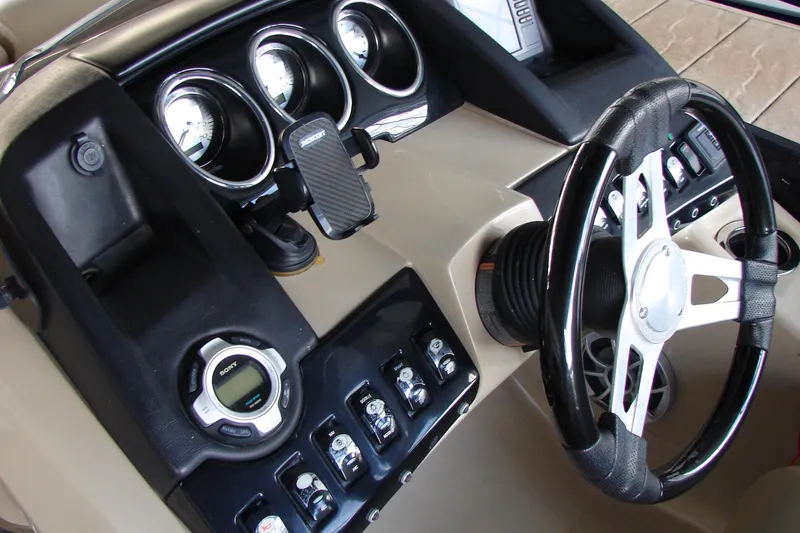 Slide: The Image of Dashboard of a 2015 Bennington 2875 QCW I/O boat with steering wheel and gauges. - 20