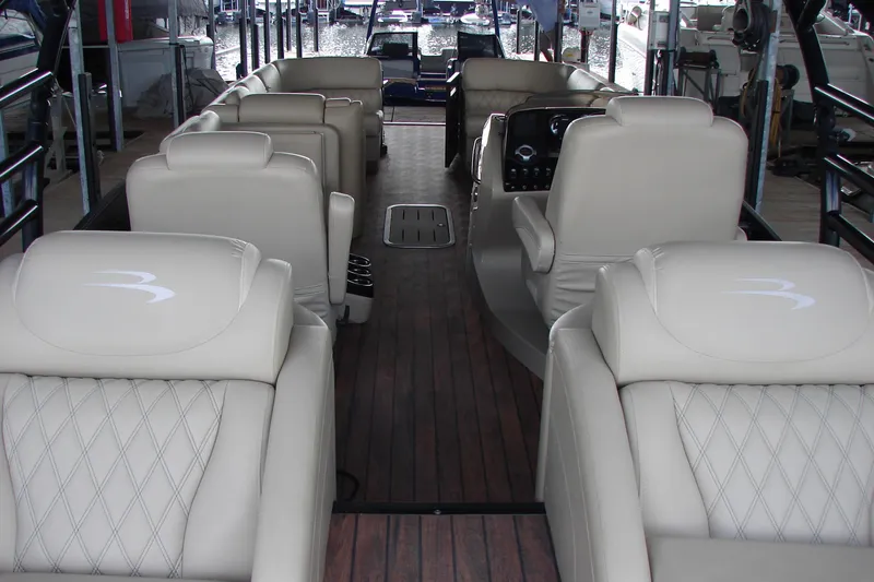 Slide: The Image of Luxurious interior of 2015 Bennington 2875 QCW I/O boat with plush seating and wood flooring. - 22