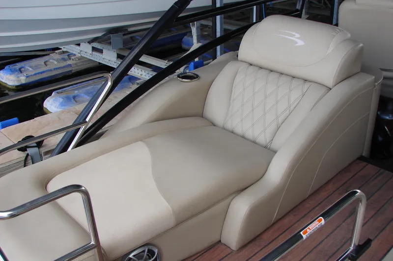 Slide: The Image of Luxurious seating on 2015 Bennington 2875 QCW I/O boat, featuring plush upholstery and elegant design. - 24