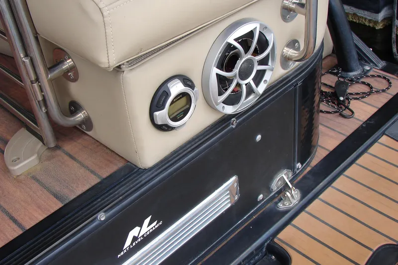 Slide: The Image of 2015 Bennington 2875 QCW I/O boat interior with speaker and control panel. - 26