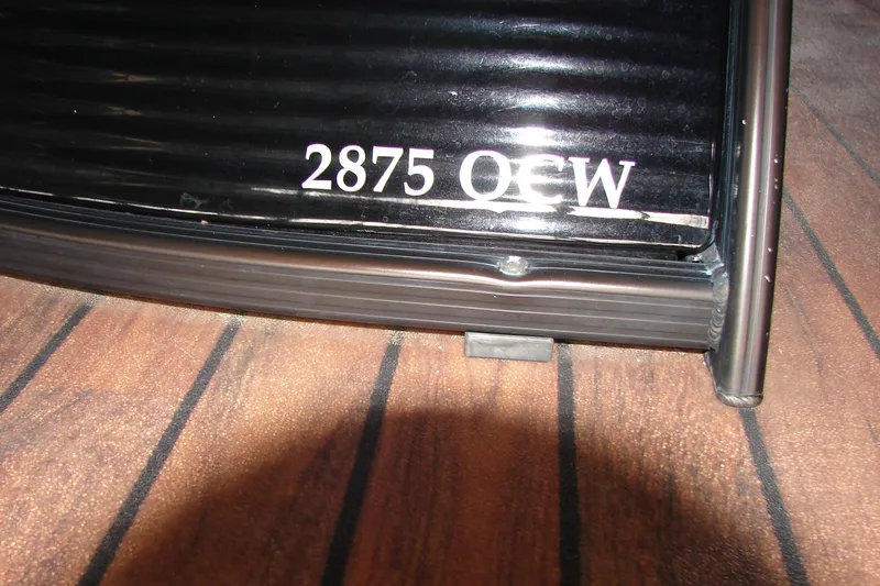 Slide: The Image of 2015 Bennington 2875 QCW I/O boat model detail on wooden deck. - 28