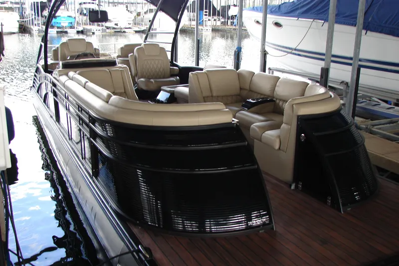 Slide: The Image of 2015 Bennington 2875 QCW I/O pontoon boat with luxurious seating at marina. - 4