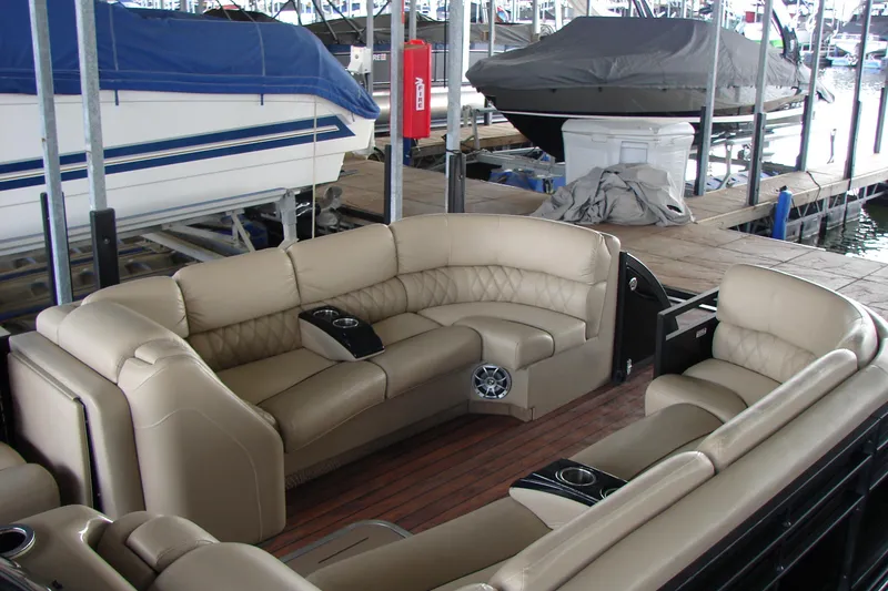 Slide: The Image of Luxurious interior of a 2015 Bennington 2875 QCW I/O pontoon boat at a marina. - 9