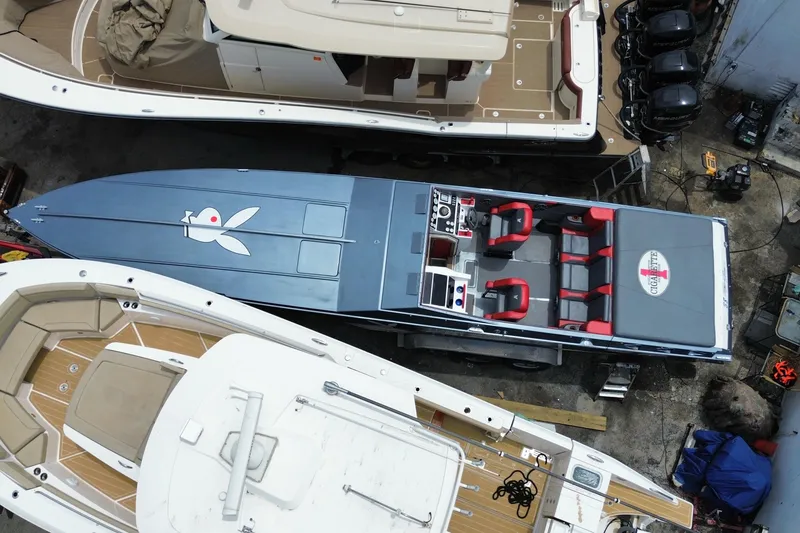 Slide: The Image of Overhead view of a 1994 Cigarette 38' Top Gun GT speedboat docked among other boats. - 12