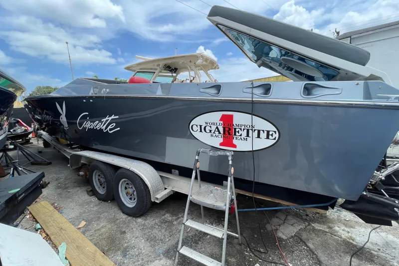 Slide: The Image of 1994 Cigarette 38' Top Gun GT boat on trailer, featuring racing team logo. - 15