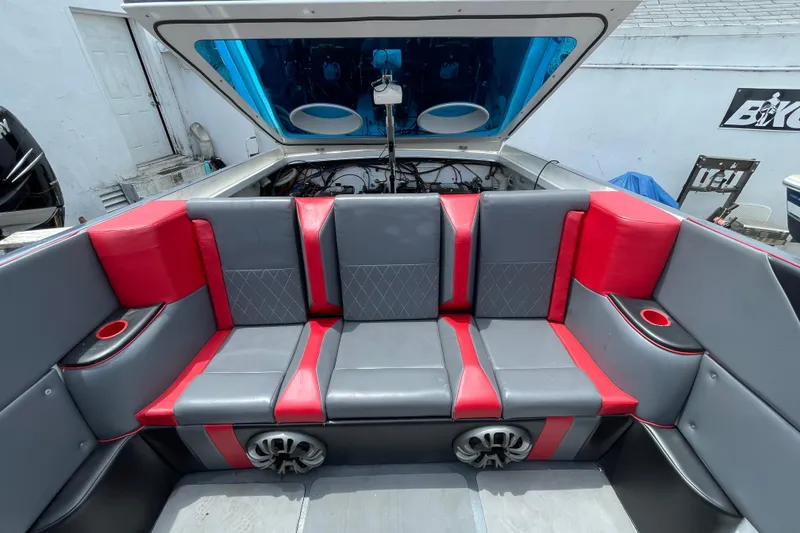 Slide: The Image of 1994 Cigarette 38' Top Gun GT boat interior with red and gray seating. - 18