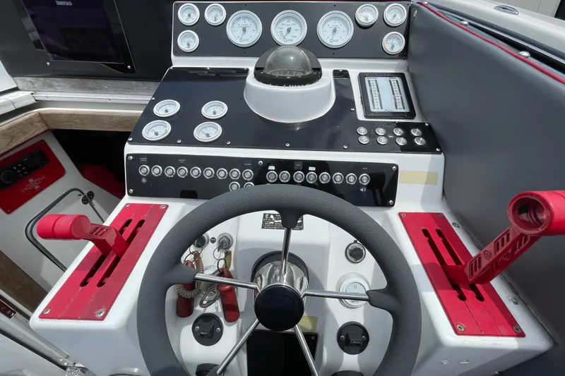 Slide: The Image of Cockpit of a 1994 Cigarette 38' Top Gun GT with gauges and controls. - 23