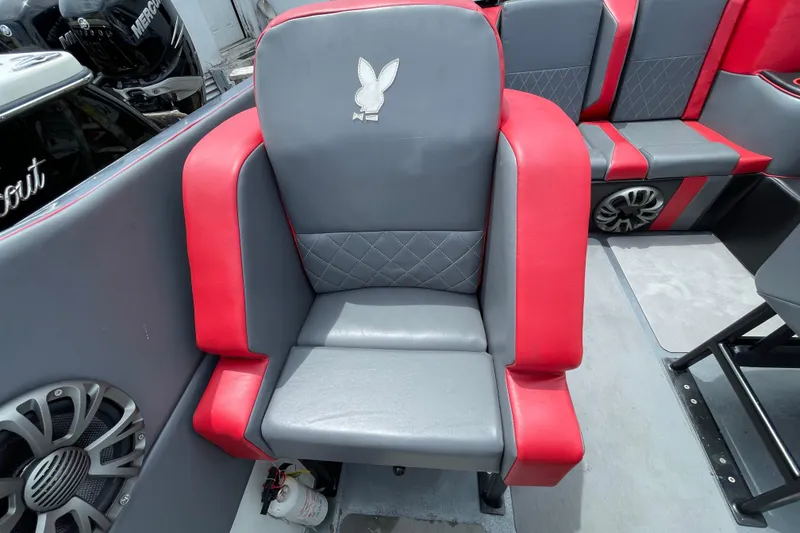 Slide: The Image of Gray and red seat on 1994 Cigarette 38' Top Gun GT boat, featuring diamond stitching and speaker. - 24