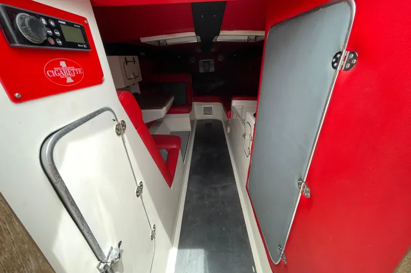 Slide: The Image of Interior of a 1994 Cigarette 38' Top Gun GT boat with red and white seating. - 26