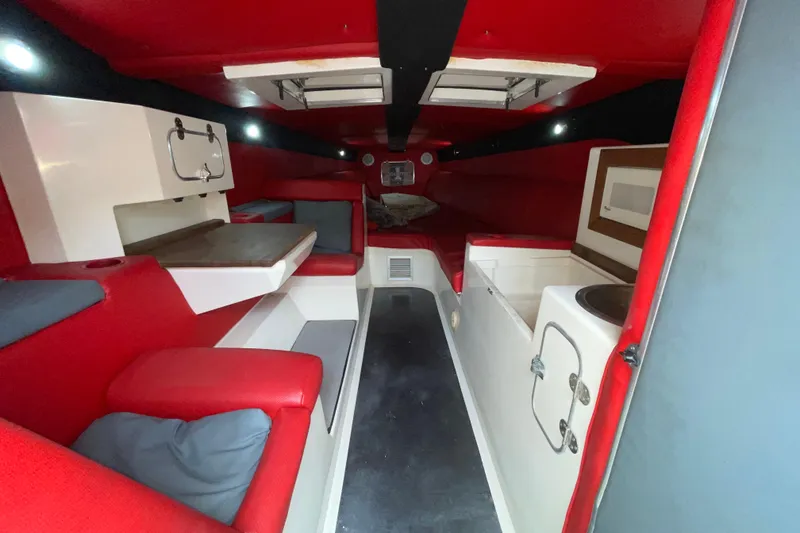 Slide: The Image of Interior of a 1994 Cigarette 38' Top Gun GT boat with red and white seating. - 27