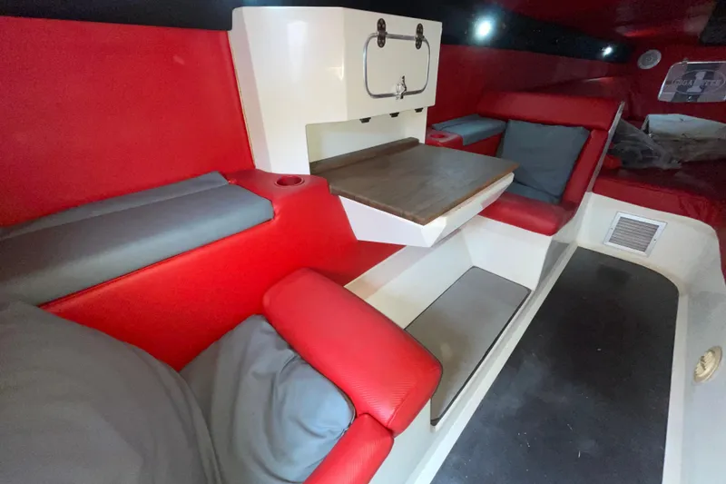 Slide: The Image of Interior of 1994 Cigarette 38' Top Gun GT with red seating and table. - 28