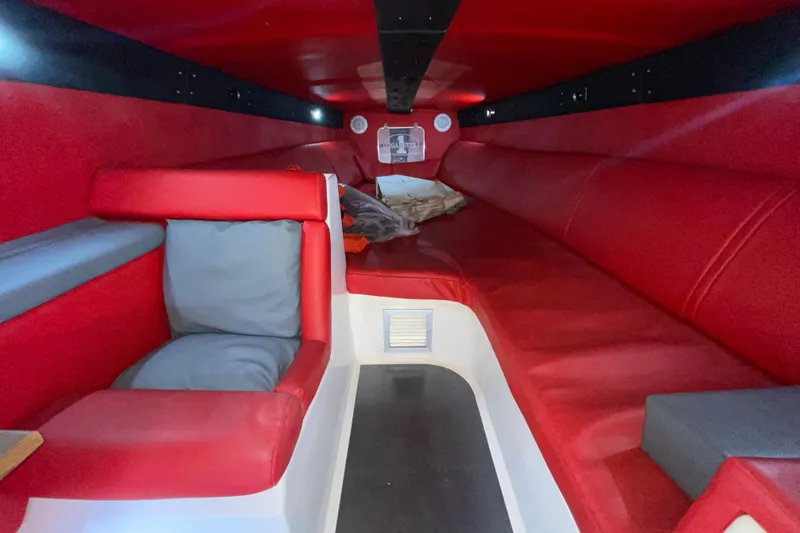 Slide: The Image of Interior of a 1994 Cigarette 38' Top Gun GT with red seating and modern design. - 30
