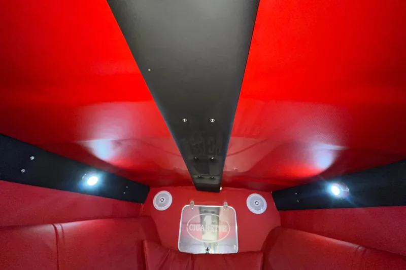 Slide: The Image of Interior of 1994 Cigarette 38' Top Gun GT boat with red upholstery and ambient lighting. - 31