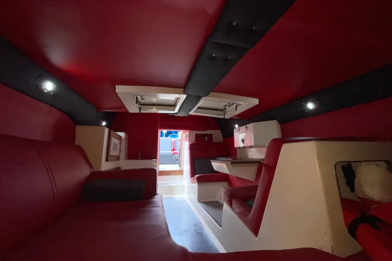 Slide: The Image of Interior of 1994 Cigarette 38' Top Gun GT boat with red and black seating. - 32