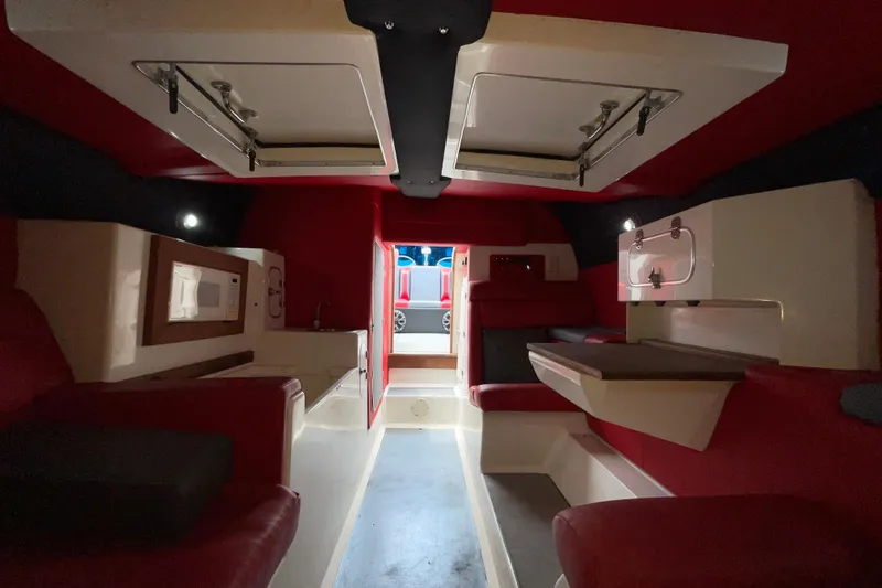 Slide: The Image of Interior of a 1994 Cigarette 38' Top Gun GT boat, featuring red and white seating. - 33