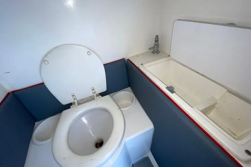 Slide: The Image of 1994 Cigarette 38' Top Gun GT boat bathroom with toilet and sink. - 34