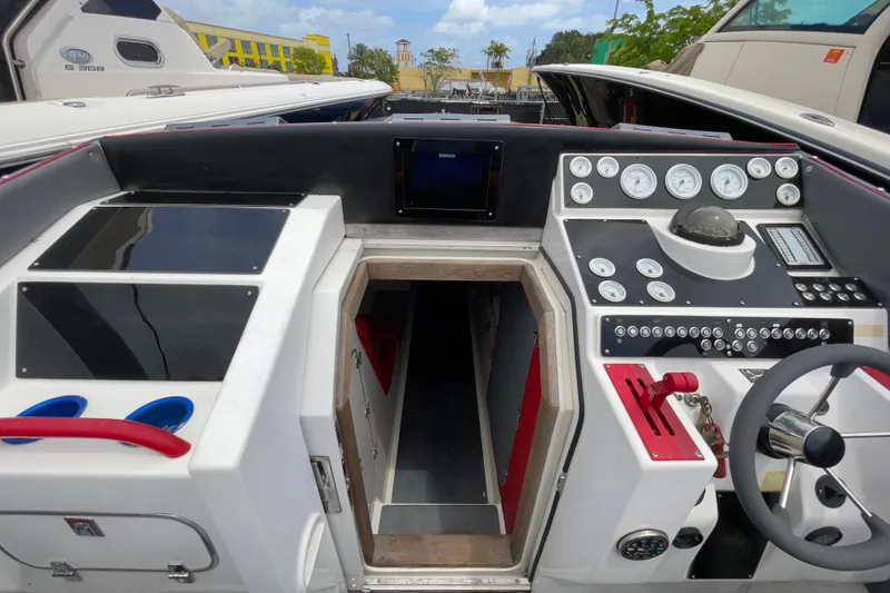 Slide: The Image of 1994 Cigarette 38' Top Gun GT boat cockpit with gauges and steering wheel. - 36