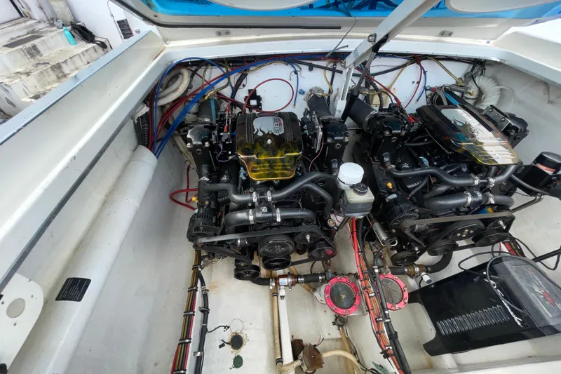 Slide: The Image of Engine compartment of a 1994 Cigarette 38' Top Gun GT boat, showcasing dual engines. - 38