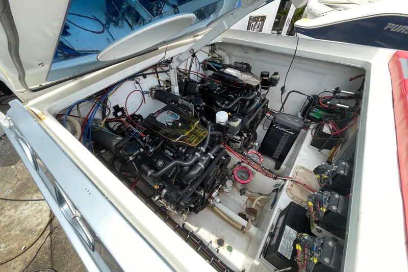 Slide: The Image of Engine compartment of a 1994 Cigarette 38' Top Gun GT boat, showcasing dual engines and wiring. - 40