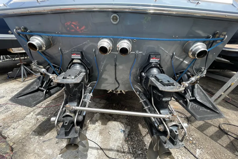 Slide: The Image of Rear view of a 1994 Cigarette 38' Top Gun GT boat with dual engines. - 43