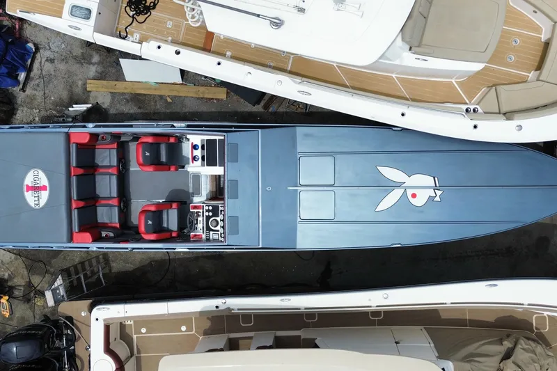 Slide: The Image of Overhead view of a 1994 Cigarette 38' Top Gun GT speedboat with red seats and distinctive logo. - 45