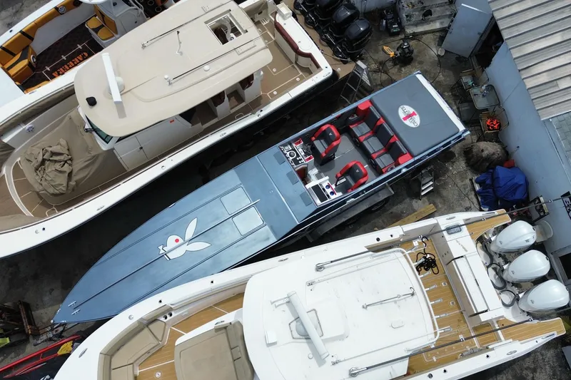 Slide: The Image of Overhead view of a 1994 Cigarette 38' Top Gun GT boat docked among other vessels. - 8