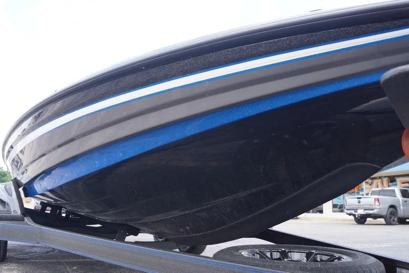 Slide: The Image of 2026 Skeeter FXR20 PRO boat hull with blue and white stripes on a trailer. - 10