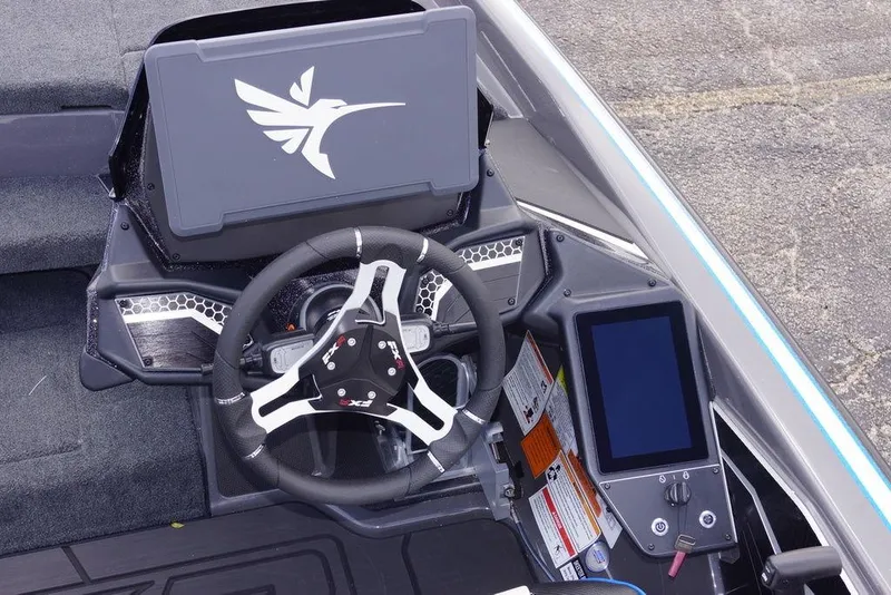 Slide: The Image of 2026 Skeeter FXR20 PRO boat cockpit with steering wheel and digital display. - 13