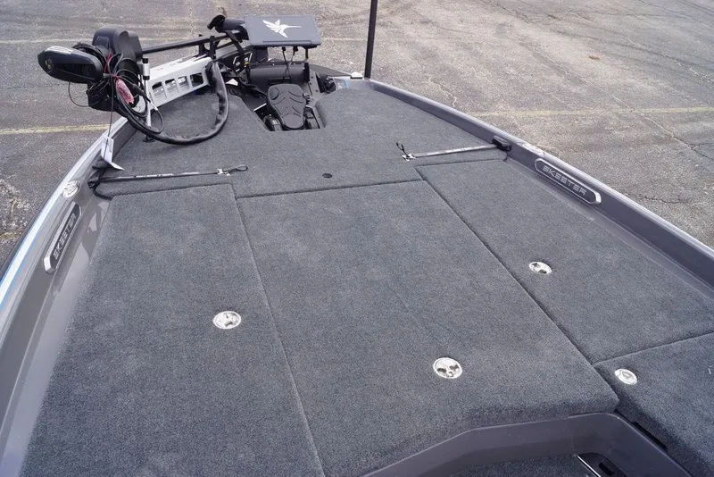Slide: The Image of 2026 Skeeter FXR20 PRO boat deck with trolling motor and carpeted surface. - 26