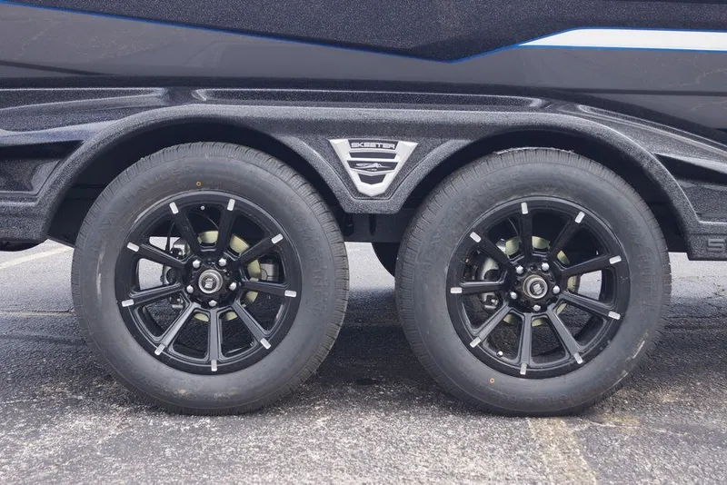 Slide: The Image of 2026 Skeeter FXR20 PRO trailer with dual black alloy wheels and sleek design. - 3