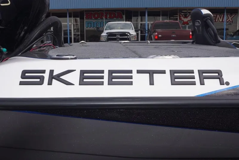 Slide: The Image of 2026 Skeeter FXR20 PRO boat with bold branding, parked outside dealership. - 4