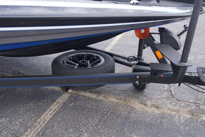 Slide: The Image of 2026 Skeeter FXR20 PRO boat trailer with spare tire on asphalt. - 7