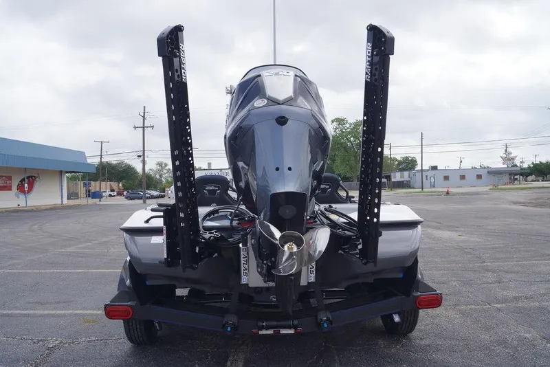 Slide: The Image of 2026 Skeeter FXR20 PRO boat rear view with dual Raptor anchors in a parking lot. - 8