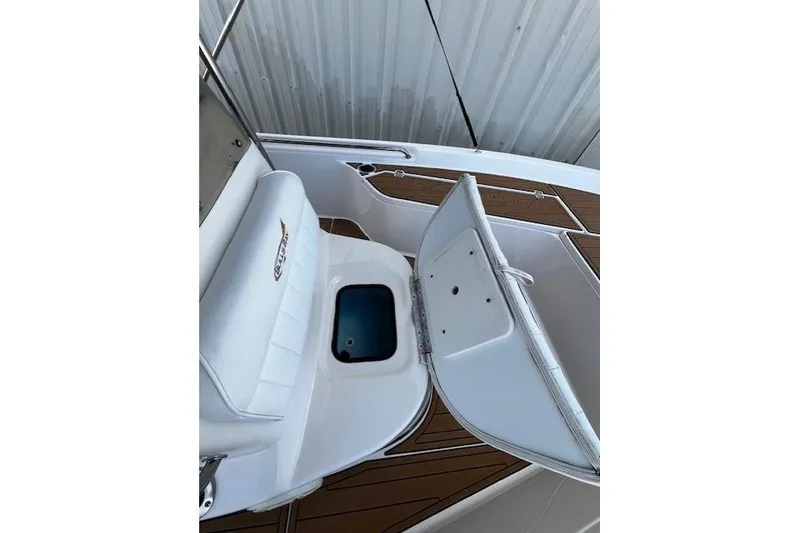 Slide: The Image of 2017 Bulls Bay 2200 boat interior with open storage compartment and cushioned seating. - 16