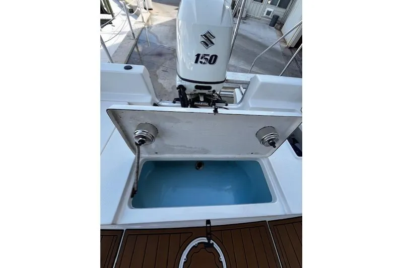 Slide: The Image of 2017 Bulls Bay 2200 boat with Suzuki 150 engine and open storage compartment. - 17