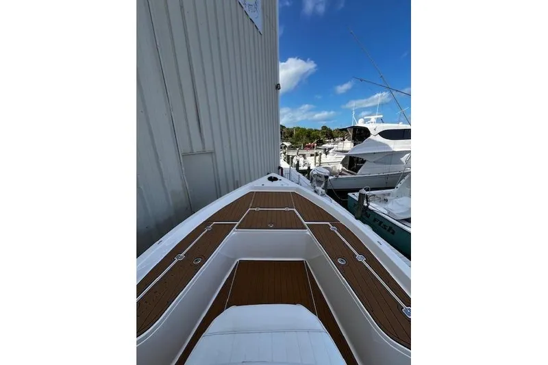 Slide: The Image of 2017 Bulls Bay 2200 boat docked, featuring sleek deck design and marina view. - 9