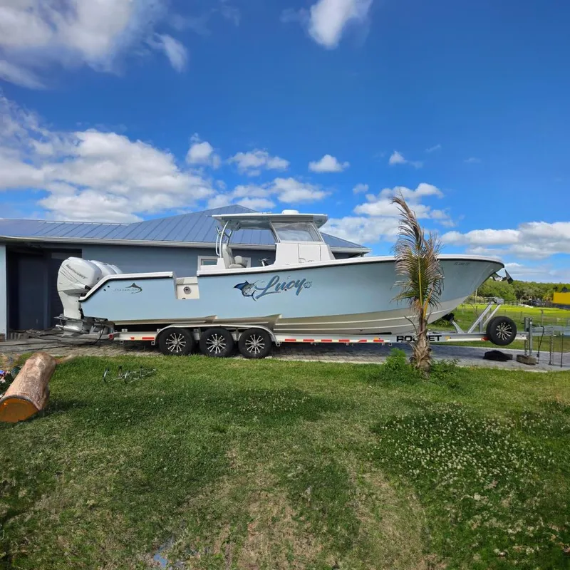 The Image of 2021 Streamline 35 CC boat on calm water, clear sky background. - 0