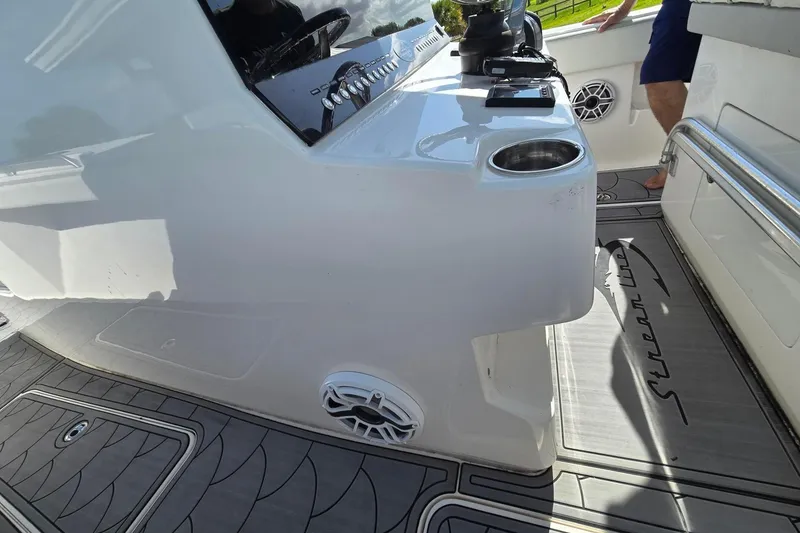 Slide: The Image of 2021 Streamline 35 CC boat with triple 350 Verado engines on calm water. - 11