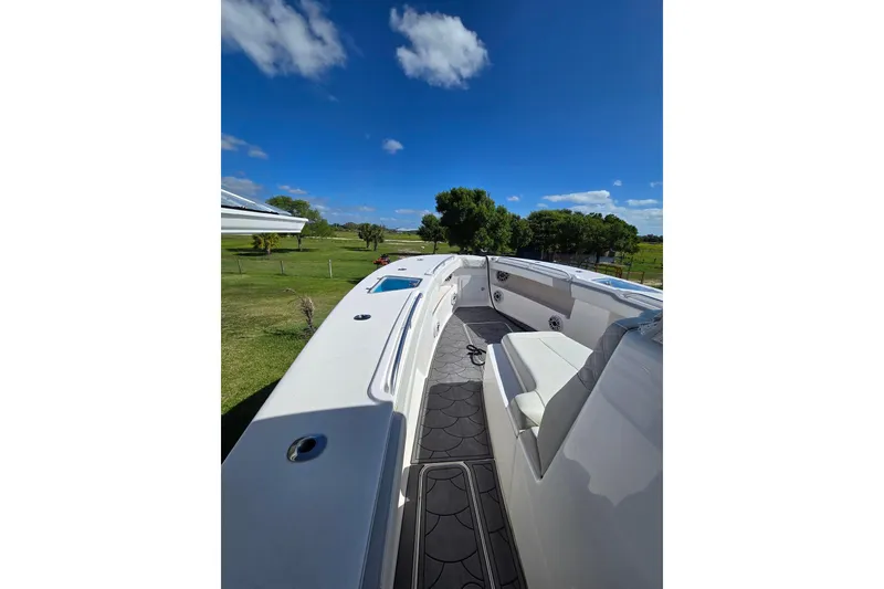 Slide: The Image of 2021 Streamline 35 CC boat with triple Mercury engines on calm water. - 13