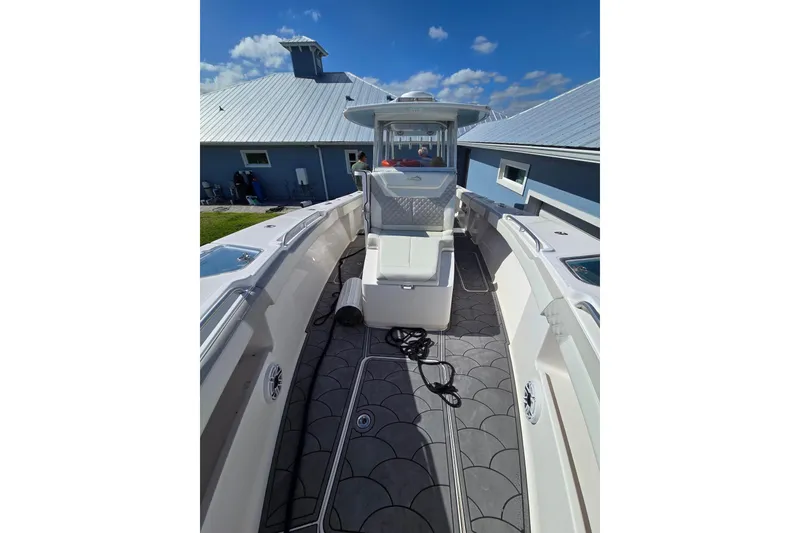 Slide: The Image of 2021 Streamline 35 CC boat on calm water, featuring twin outboard engines. - 15