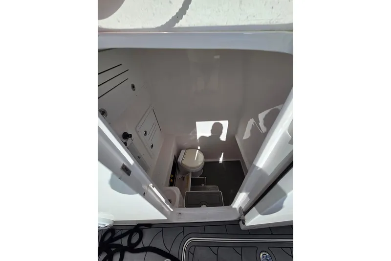 Slide: The Image of Bow view of 2021 Streamline 35 CC boat on calm water under clear sky. - 22