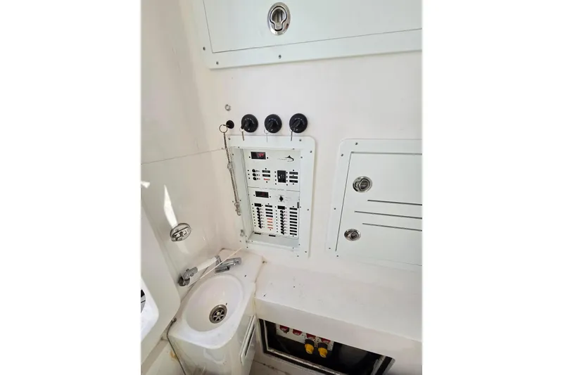 Slide: The Image of Streamline 35 CC 2021 boat interior with seating and storage, on calm water. - 23