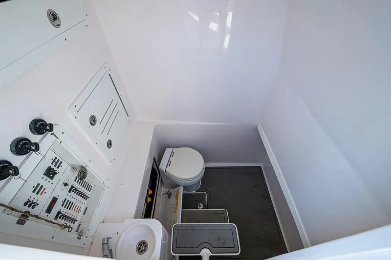 Slide: The Image of Interior of 2021 Streamline 35 CC boat featuring a compact bathroom with control panel. - 28