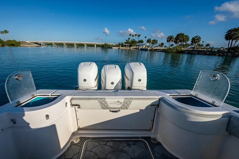 Slide: The Image of 2021 Streamline 35 CC boat with triple engines on calm water, clear sky background. - 29