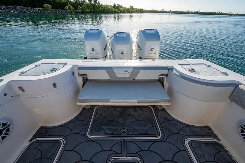 Slide: The Image of Streamline 35 CC 2021 boat with triple engines on calm water. - 32