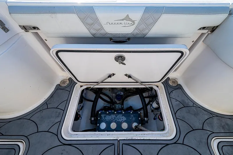 Slide: The Image of 2021 Streamline 35 CC boat hatch open, revealing internal components and storage area. - 33