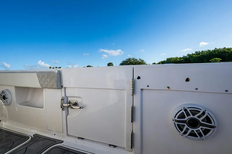 Slide: The Image of 2021 Streamline 35 CC boat interior with speakers and storage, under clear blue sky. - 34