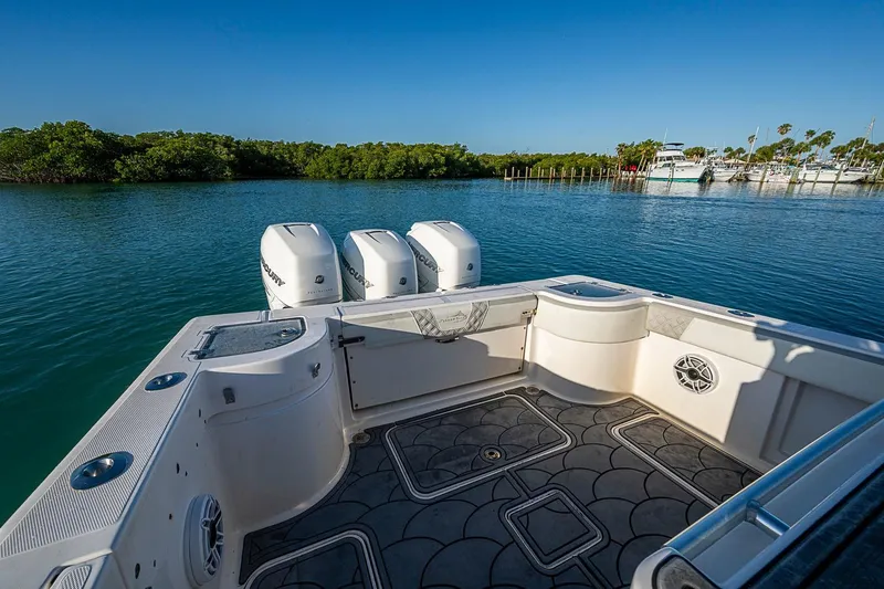 Slide: The Image of 2021 Streamline 35 CC boat with triple outboard engines on calm water. - 35