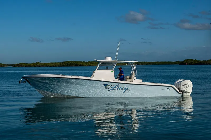 Slide: The Image of 2021 Streamline 35 CC boat on calm water under clear blue sky. - 38